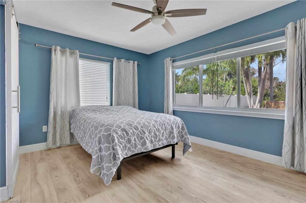 Bedroom featuring wood finished floors and a ceiling fan
