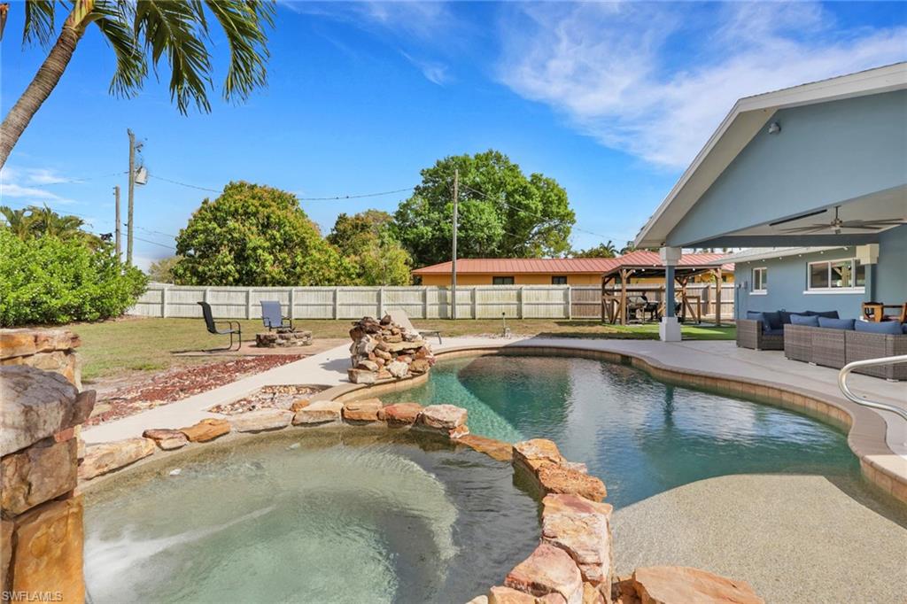 Integrated pool / spa with outdoor lounge area, a patio, a gazebo, and a fenced backyard