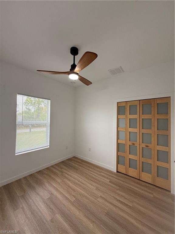 Unfurnished room featuring light wood finished floors and a ceiling fan