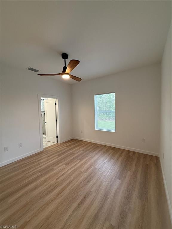 Empty room with light wood-type flooring and ceiling fan