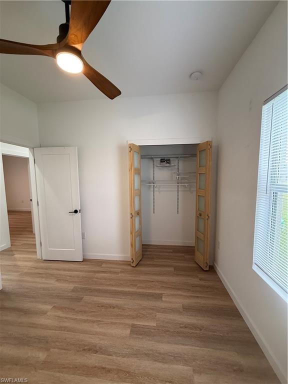 Unfurnished bedroom with a ceiling fan, light wood-type flooring, and a closet