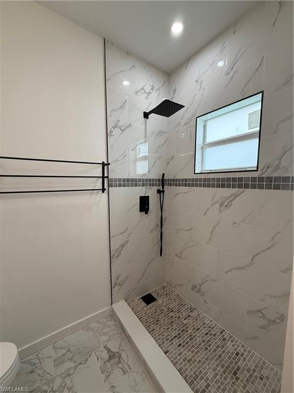 Bathroom with a marble finish shower, light marble finish flooring, and recessed lighting