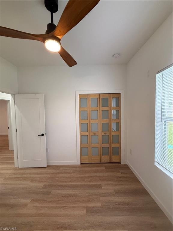 Spare room featuring light wood finished floors and a ceiling fan