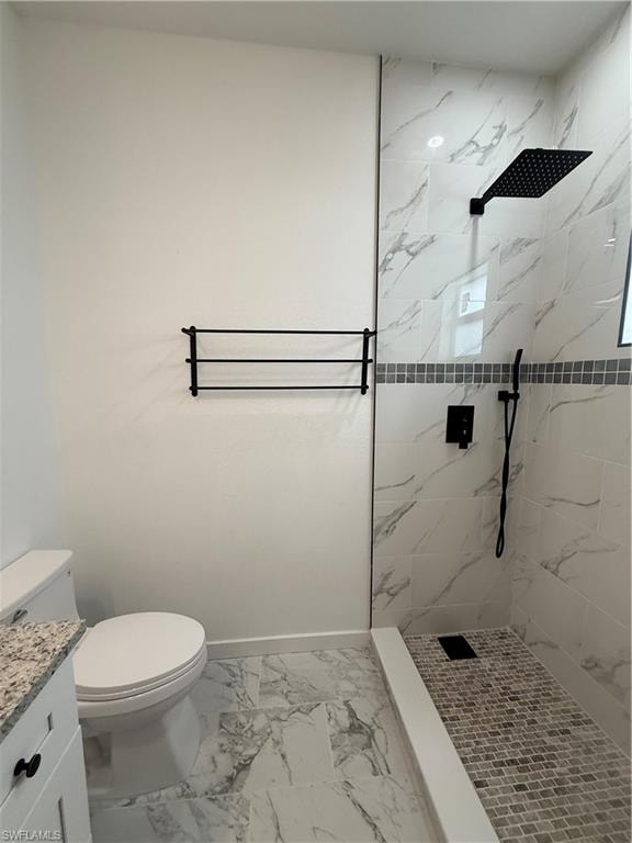 Full bathroom featuring a marble finish shower, vanity, and light marble finish flooring