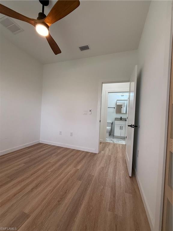 Empty room featuring light wood-style flooring and a ceiling fan