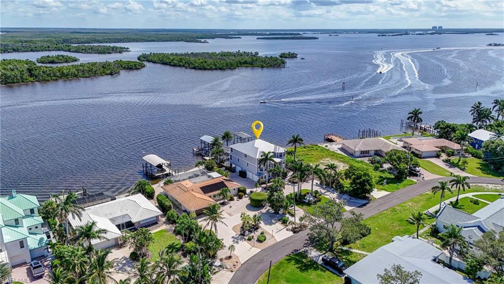 Aerial view of residential area featuring a nearby body of water - Virtually Edited Image