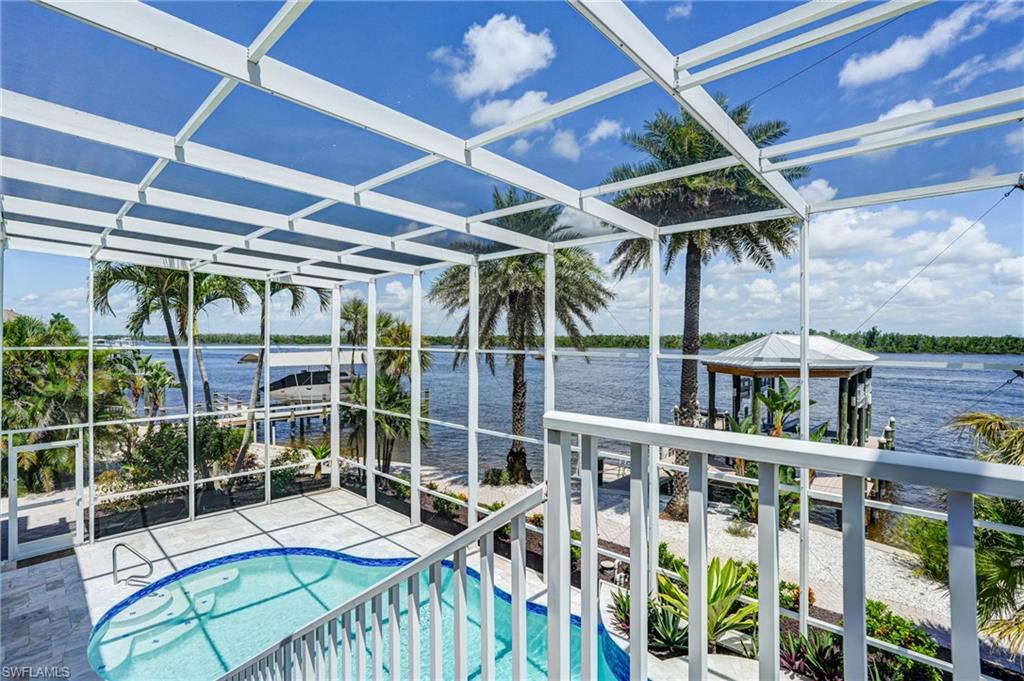 Swimming pool with a lanai and a water view - Virtually Edited Image