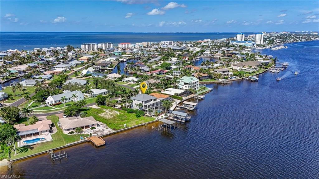 Aerial perspective of suburban area featuring a nearby body of water - Virtually Edited Image