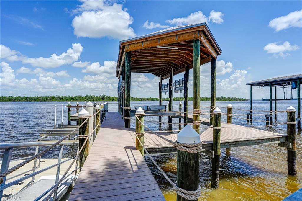 Dock area with a water view and boat lift - Virtually Edited Image