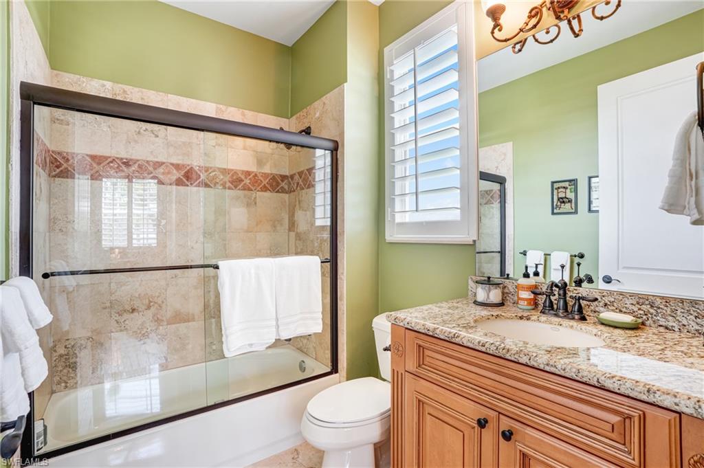 Bathroom with enclosed tub / shower combo and vanity - Virtually Edited Image