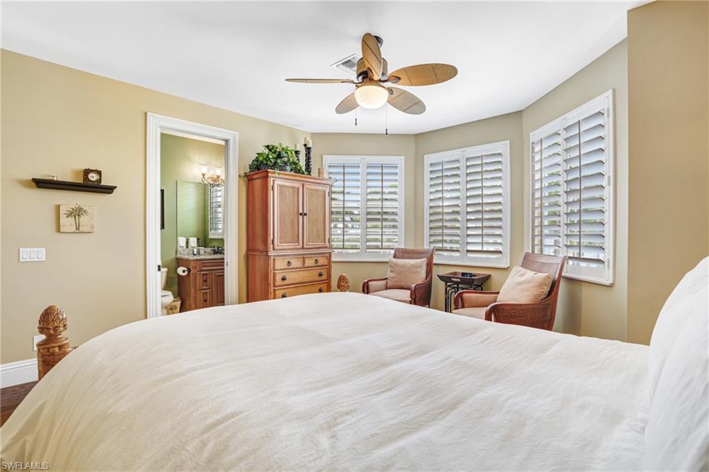 Bedroom with a ceiling fan and ensuite bath - Virtually Edited Image