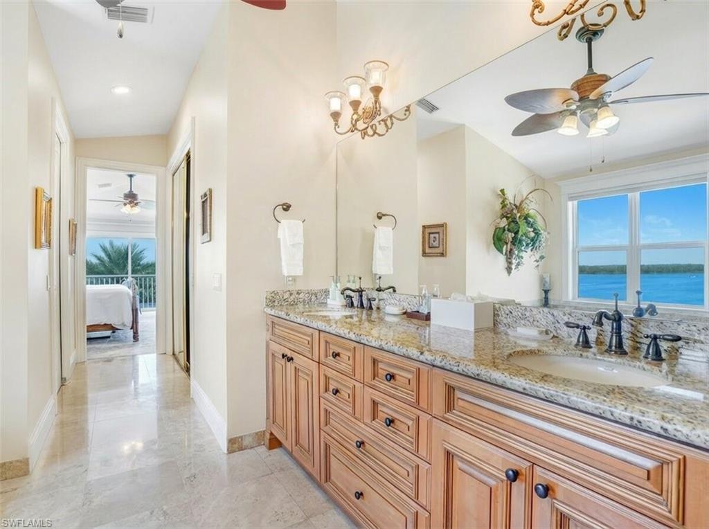 Ensuite bathroom with ceiling fan, double vanity, and recessed lighting - Virtually Edited Image