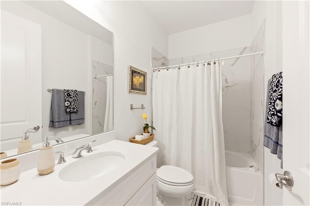 Full bath with vanity and shower / bath combo