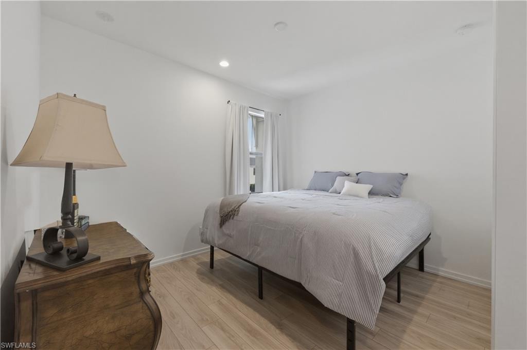 Bedroom featuring light wood-type flooring and recessed lighting