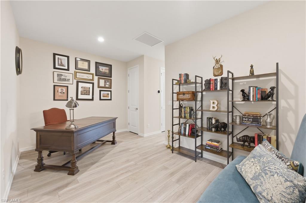 Home office featuring light wood-type flooring and recessed lighting