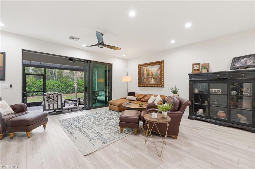 Living room featuring a ceiling fan, light wood-style flooring, and recessed lighting