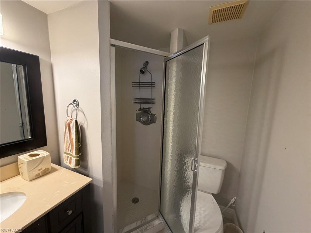 Bathroom with vanity and a stall shower