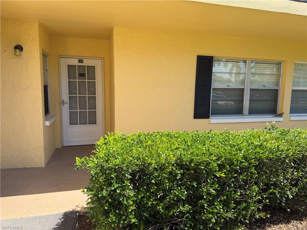 Entrance to property featuring stucco siding