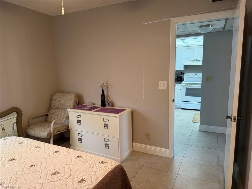 Bedroom featuring light tile patterned flooring and baseboards