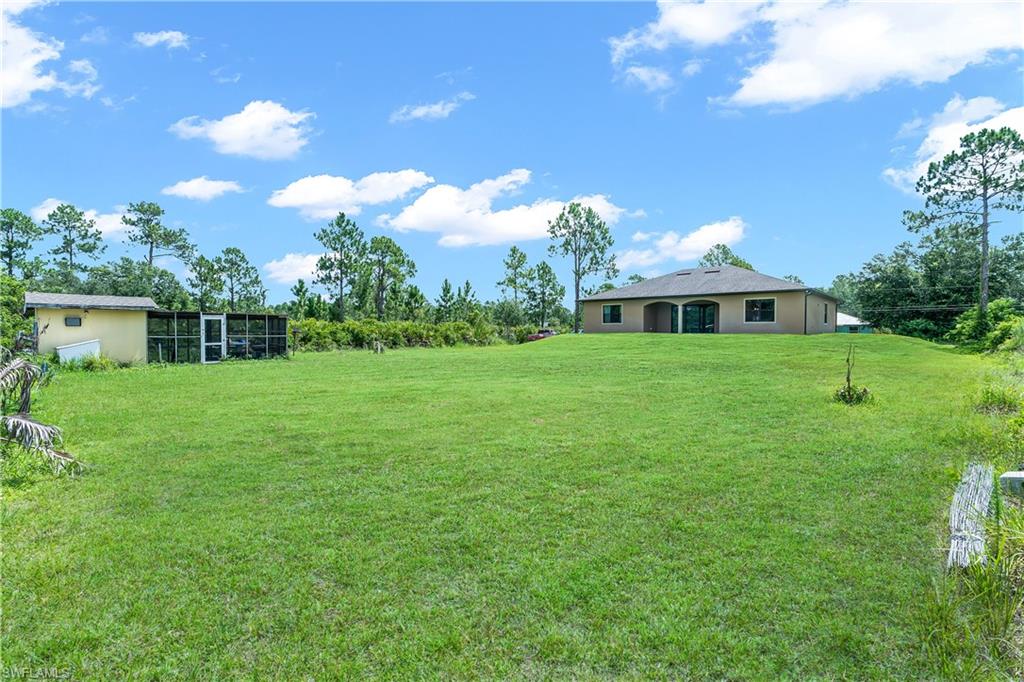 Expansive green lawn with a detached auxiliary structure