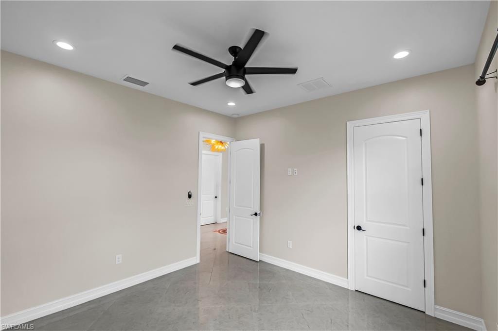 Spacious room featuring gray tile flooring and light neutral walls