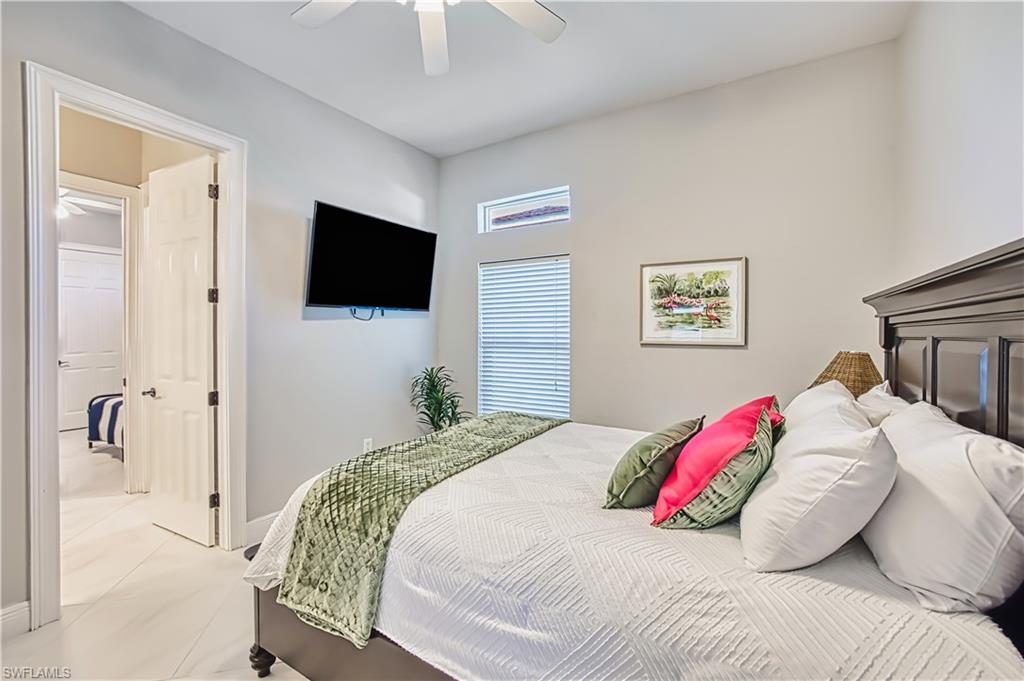 Bedroom featuring a ceiling fan and baseboards