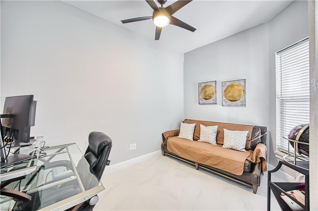 Office space with ceiling fan and healthy amount of natural light