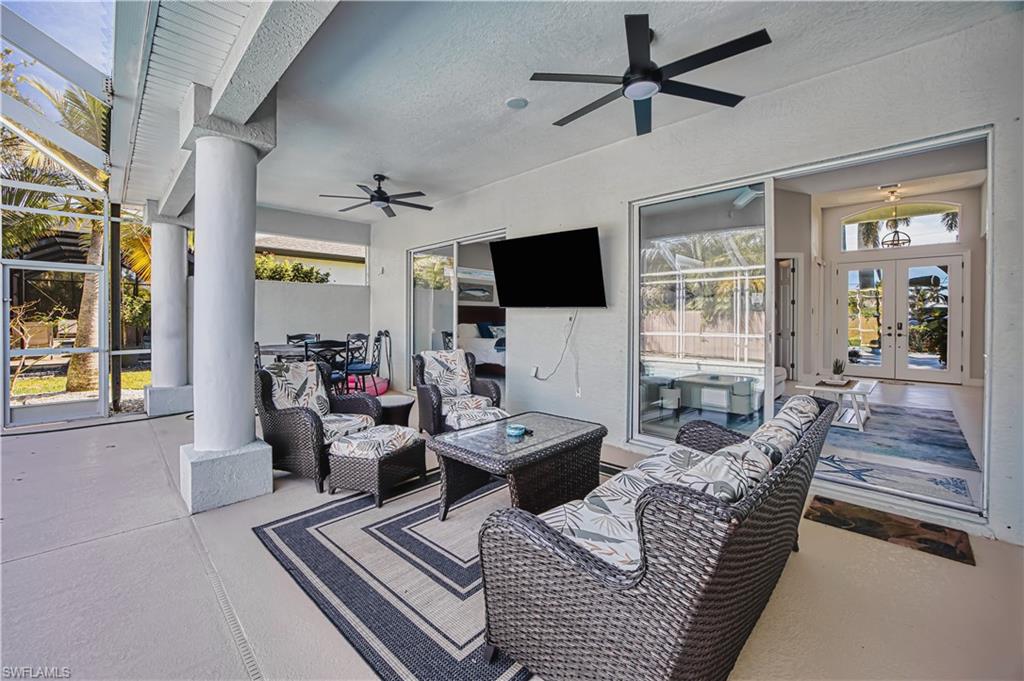 View of patio featuring an outdoor lounge area, french doors, and a ceiling fan