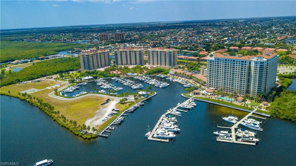 Aerial view of property's location featuring a nearby body of water and a marina