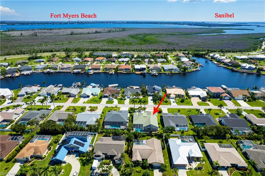 Aerial overview of property's location with a nearby body of water and nearby suburban area