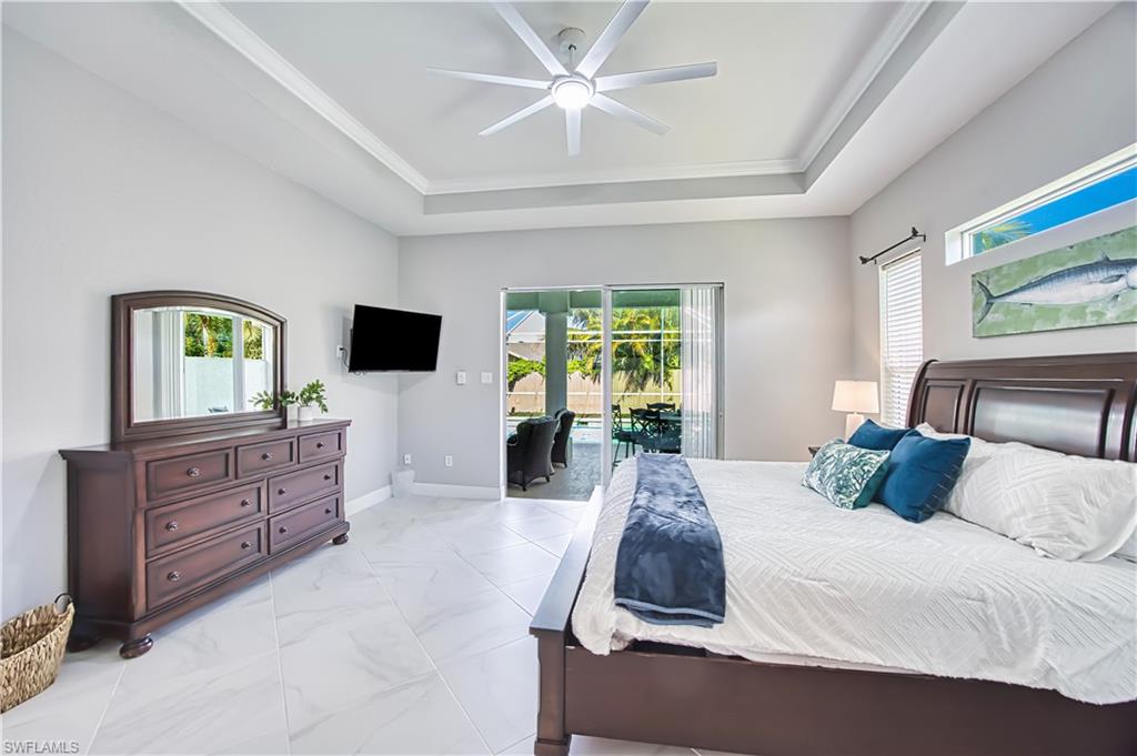 Bedroom featuring a ceiling fan, access to outside, and crown molding