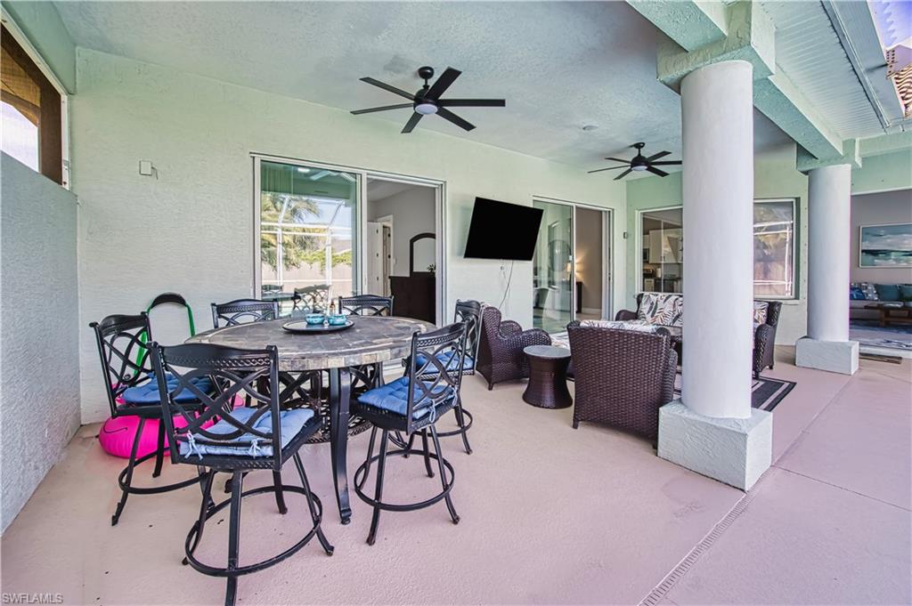 View of patio featuring outdoor dining area and ceiling fan