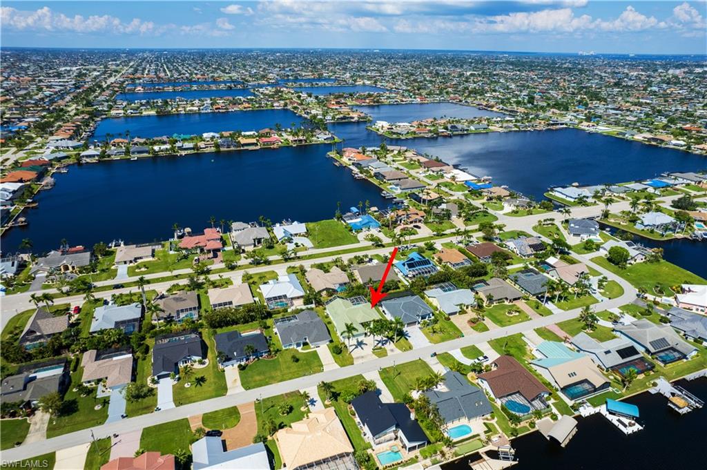 Aerial overview of property's location featuring nearby suburban area and a nearby body of water