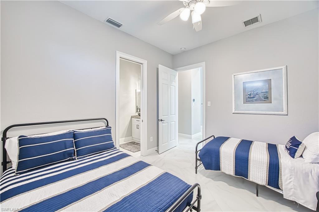 Bedroom featuring ceiling fan and connected bathroom