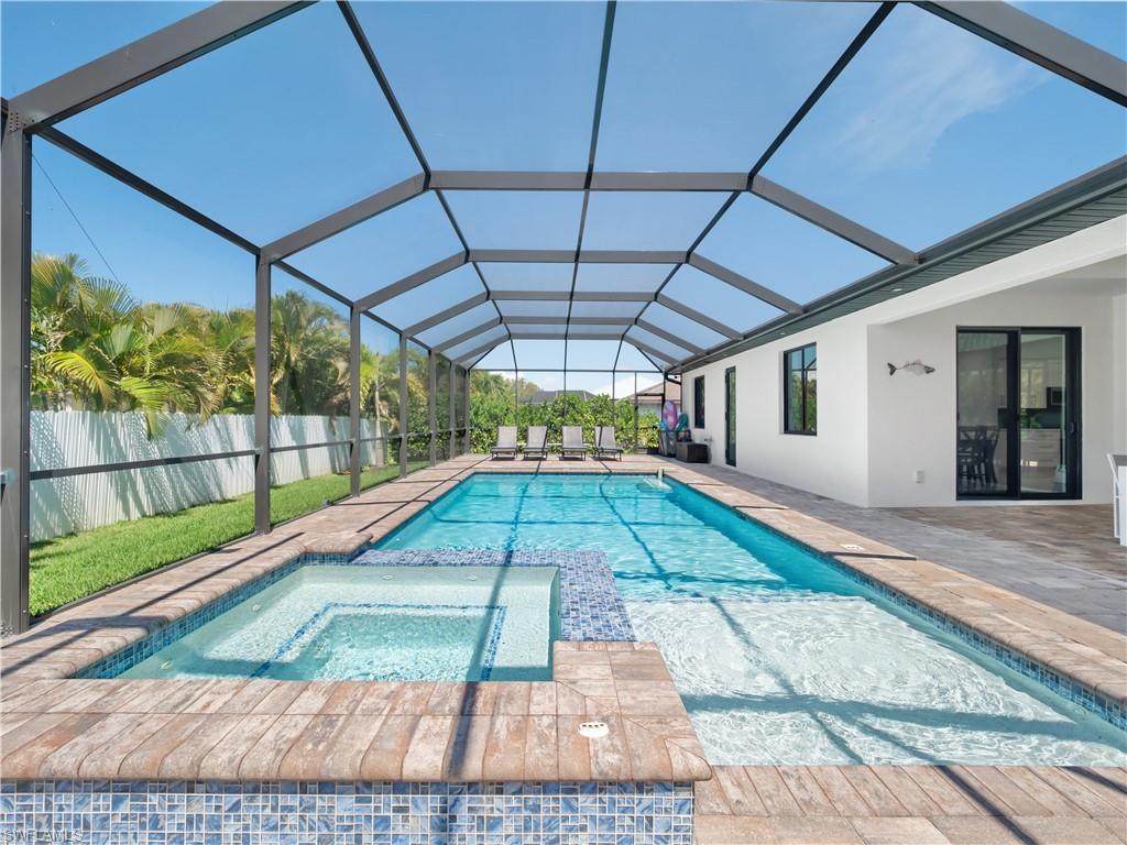 Combined pool / hot tub with a sunroom, a patio, and a lanai
