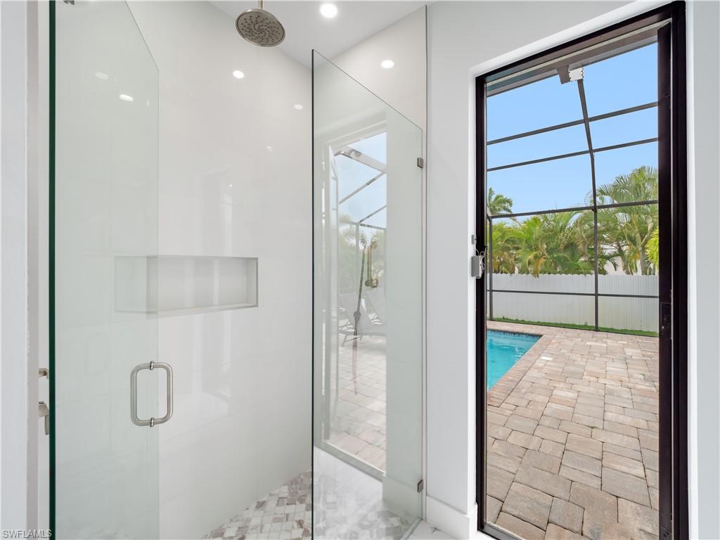 Bathroom with a shower stall and recessed lighting