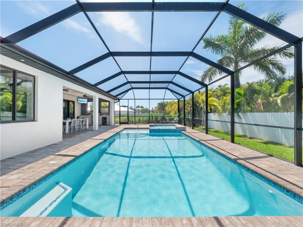 Integrated pool / spa with a sunroom, a patio area, and glass enclosure