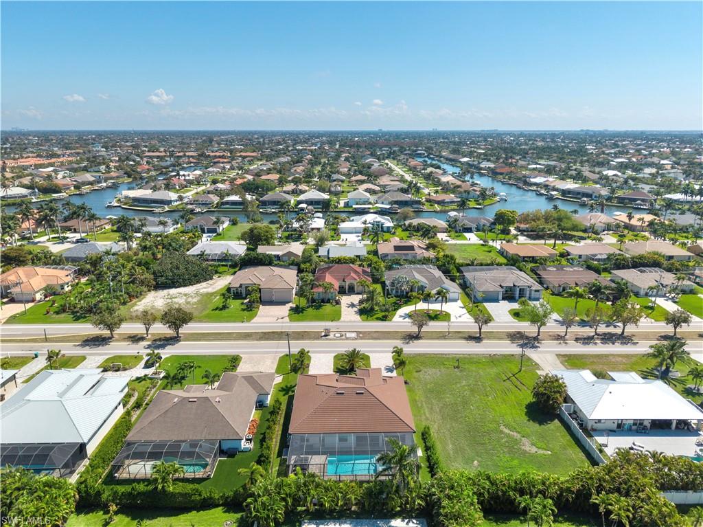 Aerial view of residential area featuring a nearby body of water