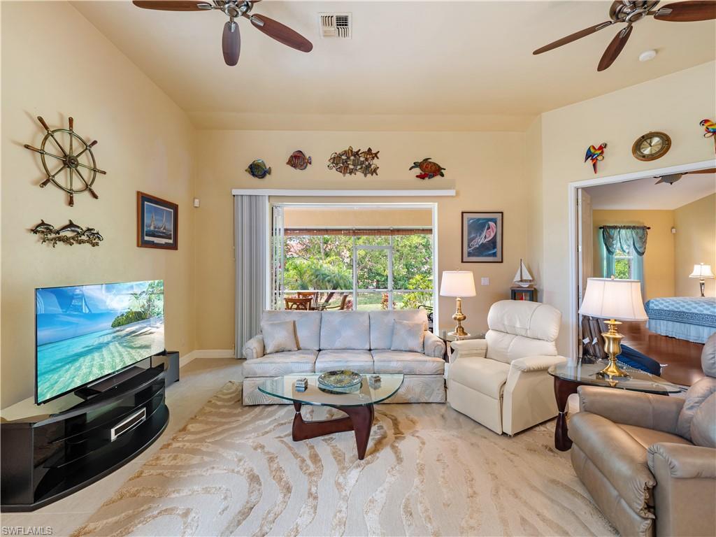 Living room featuring a ceiling fan and healthy amount of natural light