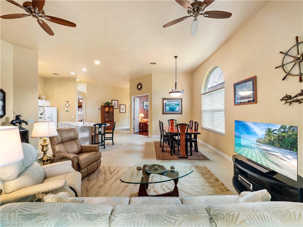 Living room featuring ceiling fan, light tile patterned floors, and recessed lighting