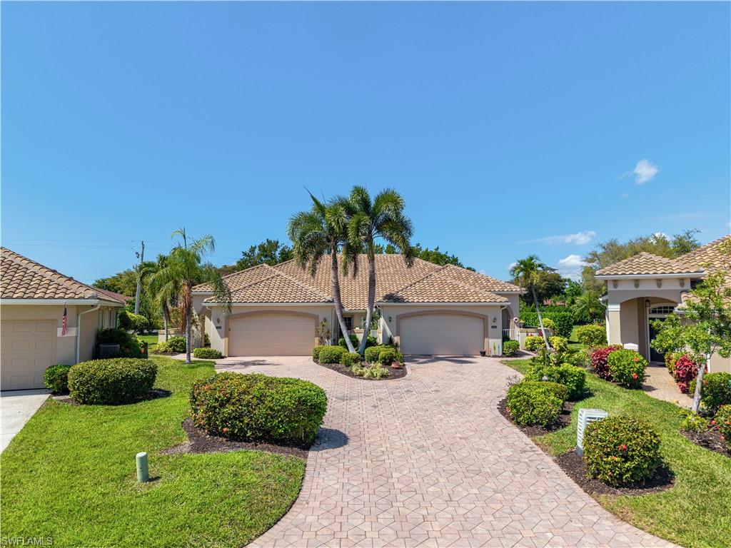 Mediterranean / spanish-style home featuring stucco siding, decorative driveway, a tiled roof, and a front yard