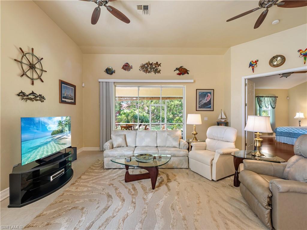 Living room with a ceiling fan and plenty of natural light