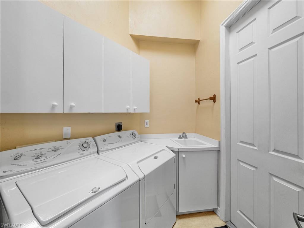 Laundry area featuring washer and dryer and cabinet space
