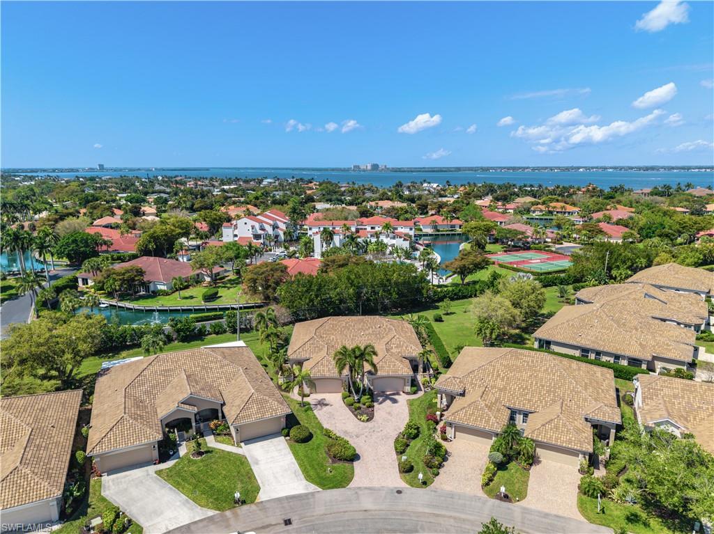 Aerial perspective of suburban area featuring a large body of water