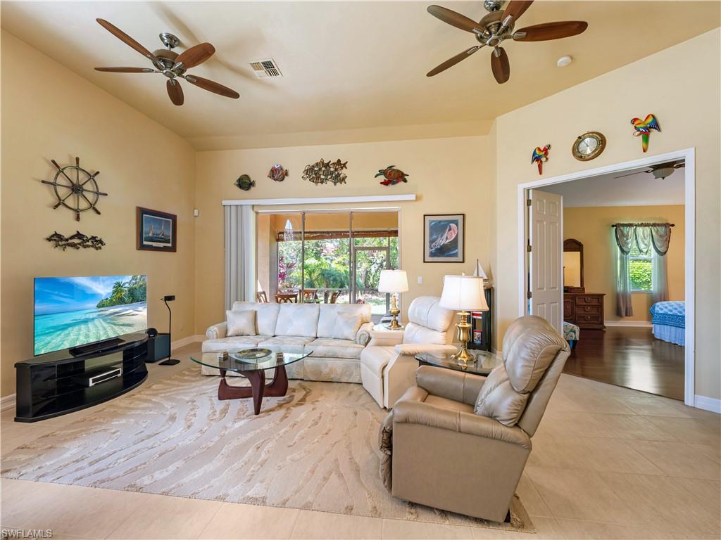 Living area featuring a ceiling fan and light tile patterned flooring