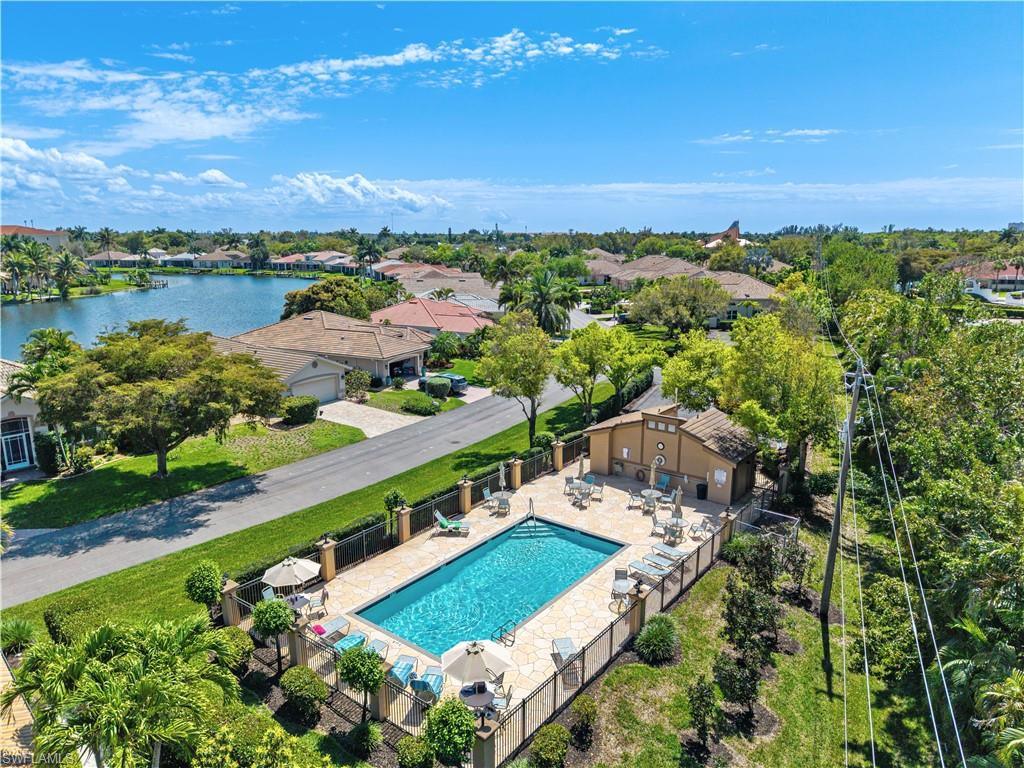 Community pool with a patio area and a water view