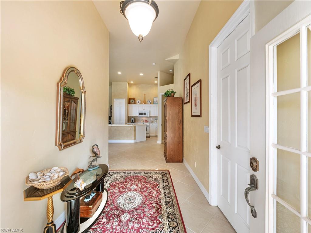 Hallway featuring light tile patterned floors and recessed lighting