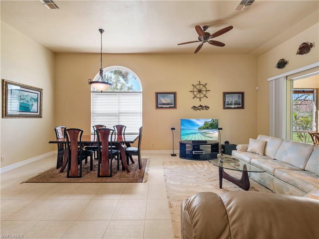 Dining area with a ceiling fan and baseboards