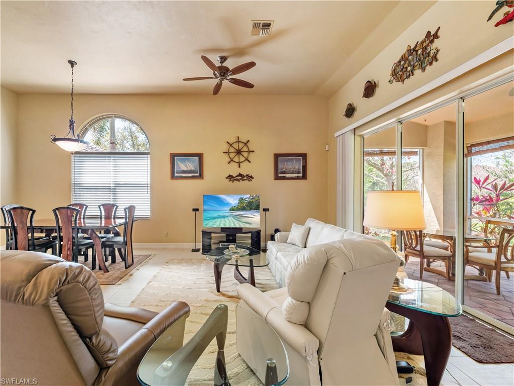 Living room featuring a ceiling fan and light tile patterned floors