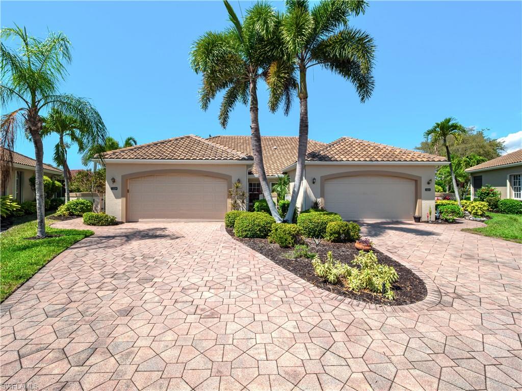 Mediterranean / spanish-style home with stucco siding, a tile roof, and driveway